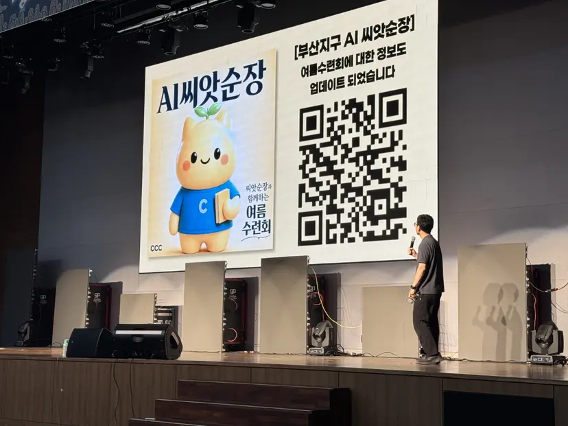 AI 씨앗순장 소개와 접속 QR 코드를 대형 화면에 띄운 무대